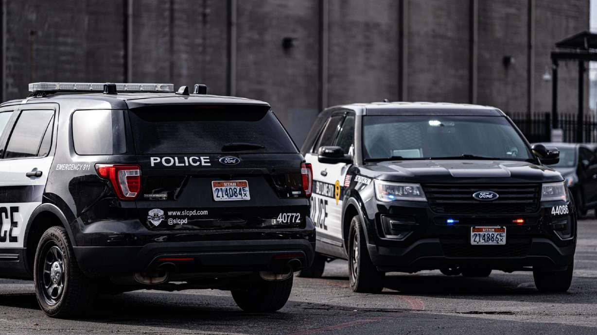 Two Salt Lake police vehicles are parked at a homicide scene at a downtown storage business, 502 W. 300 South, where a a man was found dead on Wednesday. Police have since arrested a man for investigation of murder.