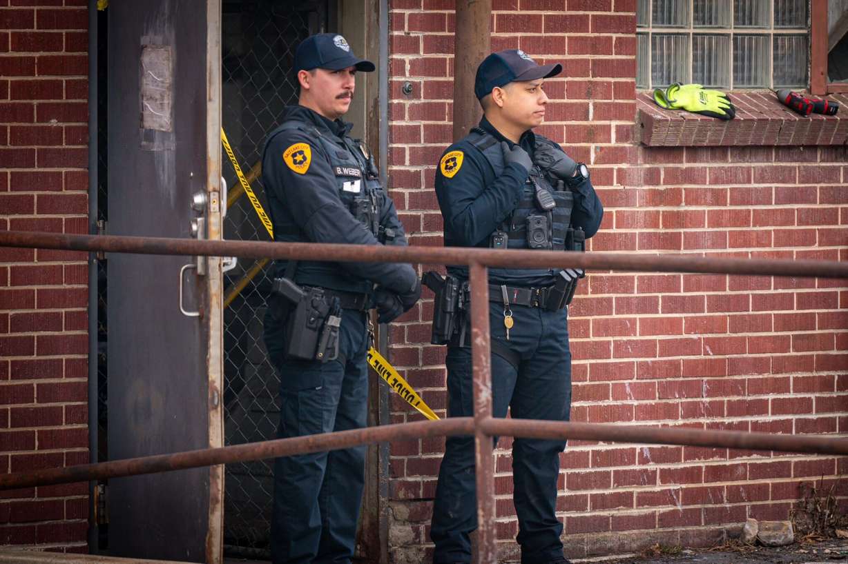Two Salt Lake police officers stand outside of a downtown storage business, 502 W. 300 South, where a man was found dead Wednesday. A man was arrested Thursday for investigation of murder.