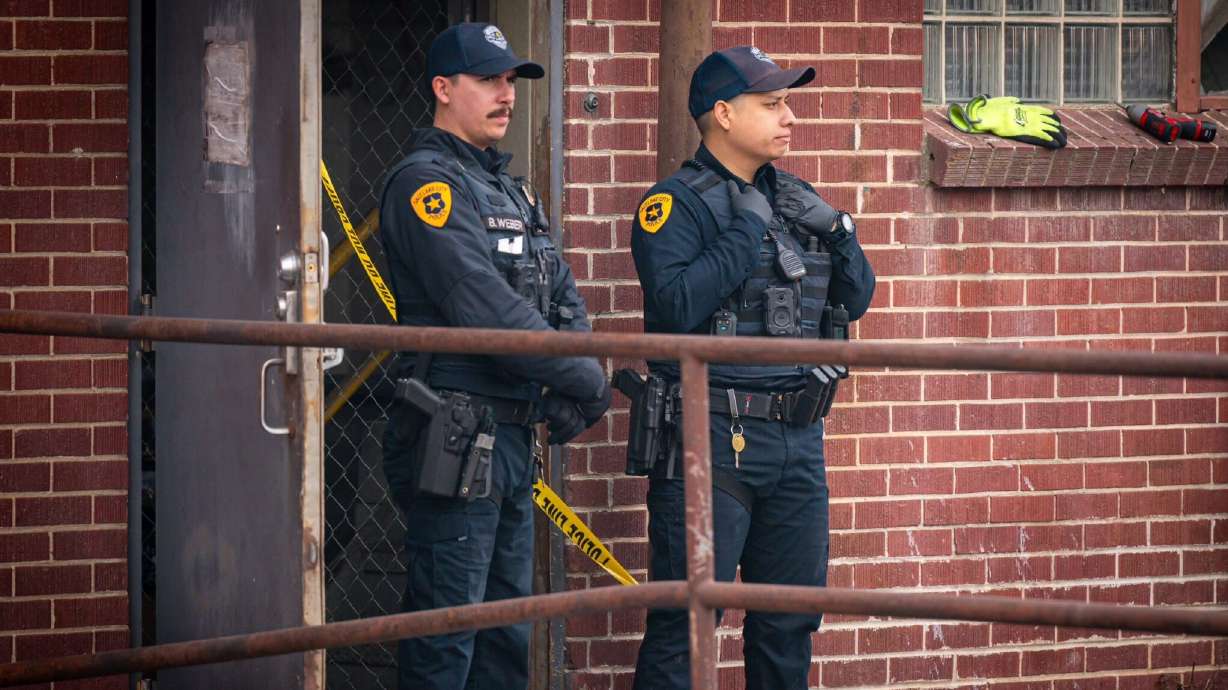 Salt Lake police officers stand outside a downtown storage business, 502 W. 300 South, where a man was found beaten to death on Jan. 3. A homeless man was charged Tuesday with murder in the man's death.
