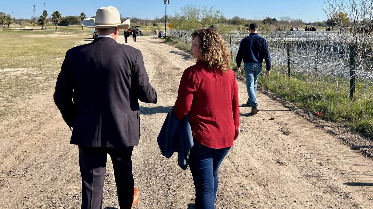 U.S. Rep. Celeste Maloy, right, walks along the US-Mexico border in Eagle Pass, Texas, with Roy Boyd, sheriff of Goliad County, Texas, on Wednesday. Around 60 GOP House members visited the border.