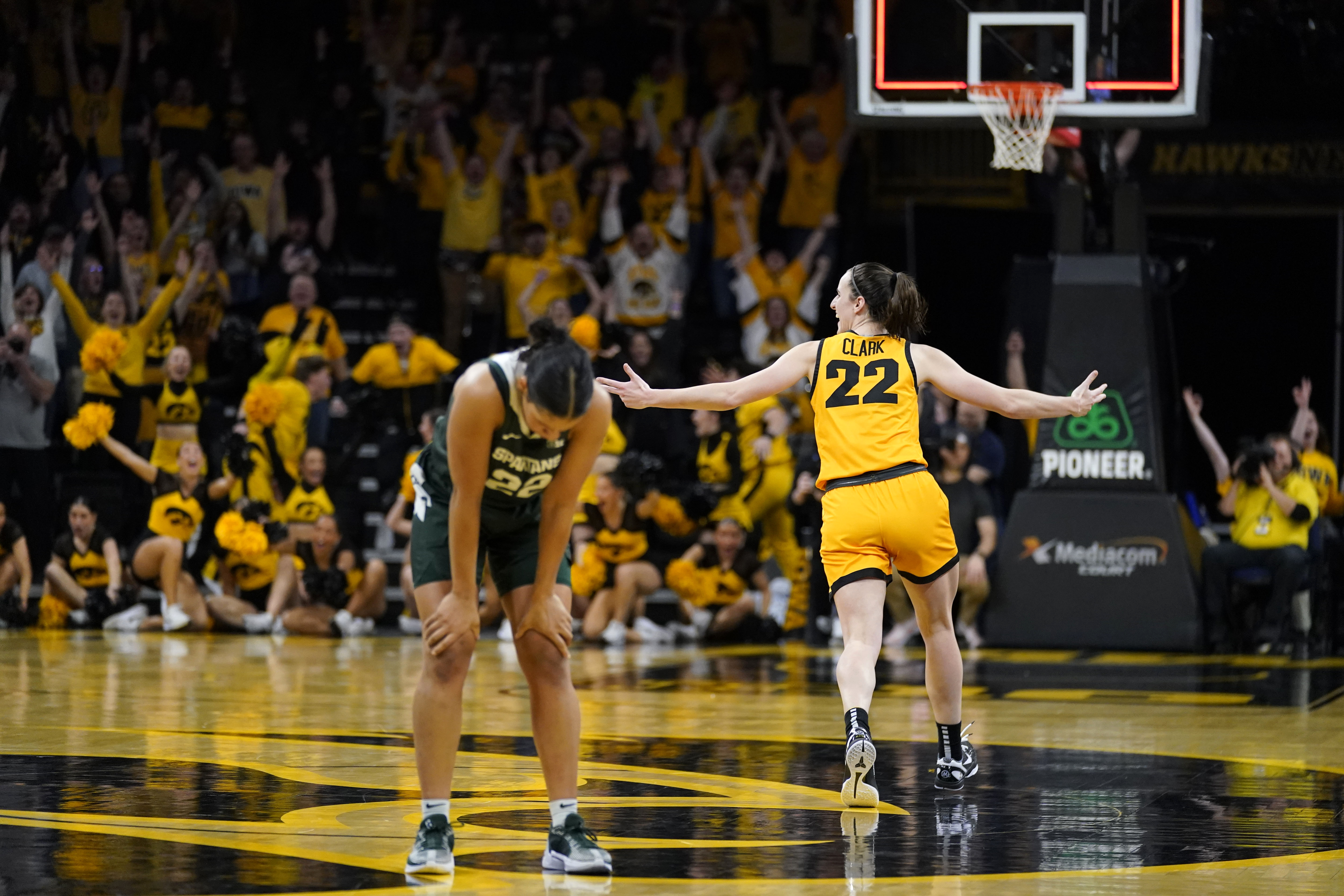 Iowa guard Caitlin Clark, right, celebrates in front of Michigan State guard Moira Joiner, left, after her three-point basket at the end of an NCAA college basketball game, Tuesday, Jan. 2, 2024, in Iowa City, Iowa. Iowa won 76-73. 