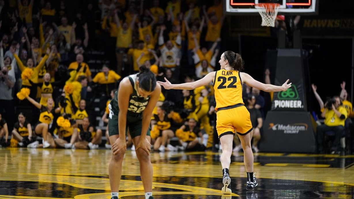 Iowa guard Caitlin Clark, right, celebrates in front of Michigan State guard Moira Joiner, left, after her three-point basket at the end of an NCAA college basketball game, Tuesday, Jan. 2, 2024, in Iowa City, Iowa. Iowa won 76-73.