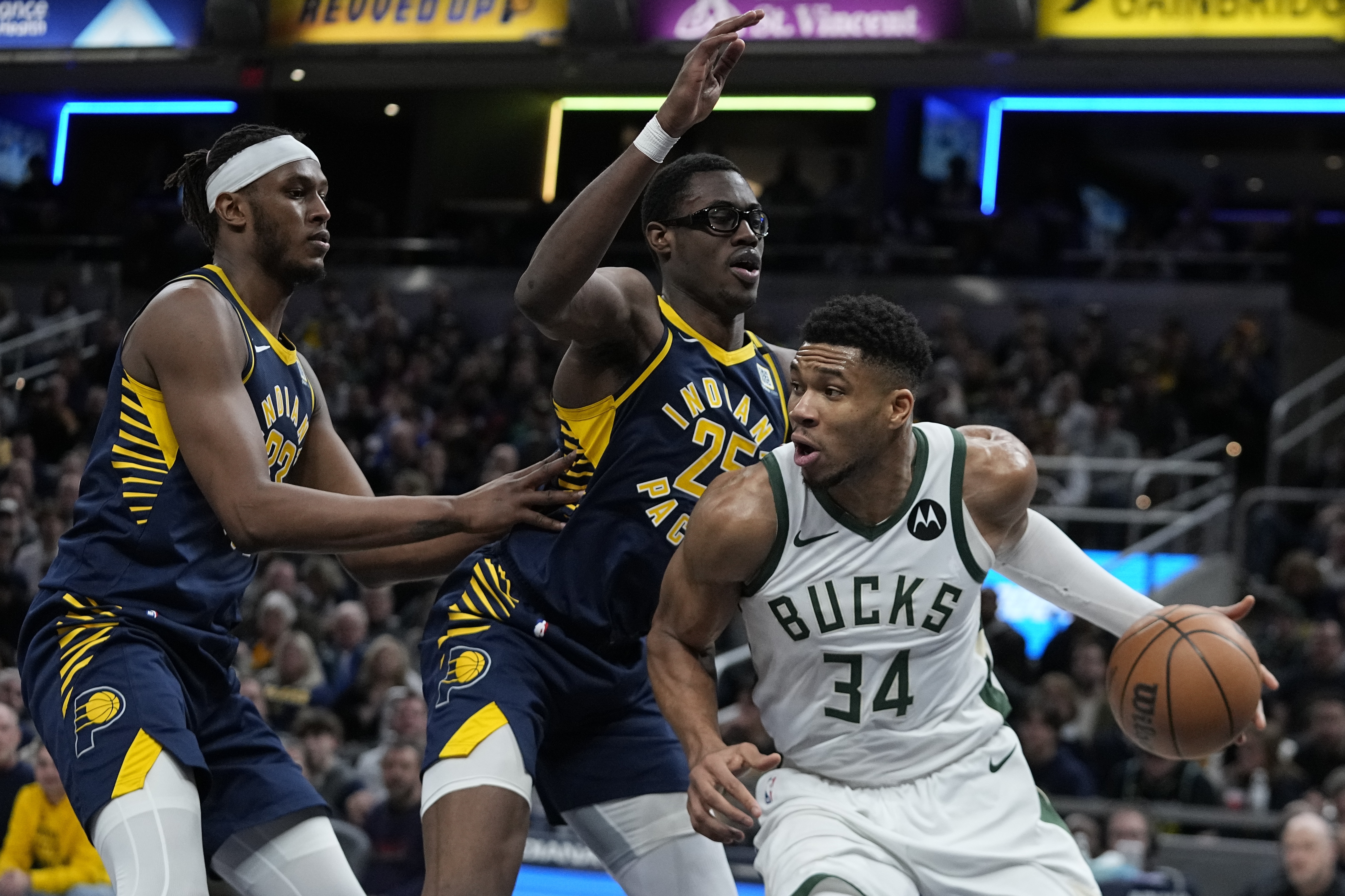 Milwaukee Bucks' Giannis Antetokounmpo (34) goes to the basket against Indiana Pacers' Myles Turner (33) and Jalen Smith (25) during the second half of an NBA basketball game, Wednesday, Jan. 3, 2024, in Indianapolis. 