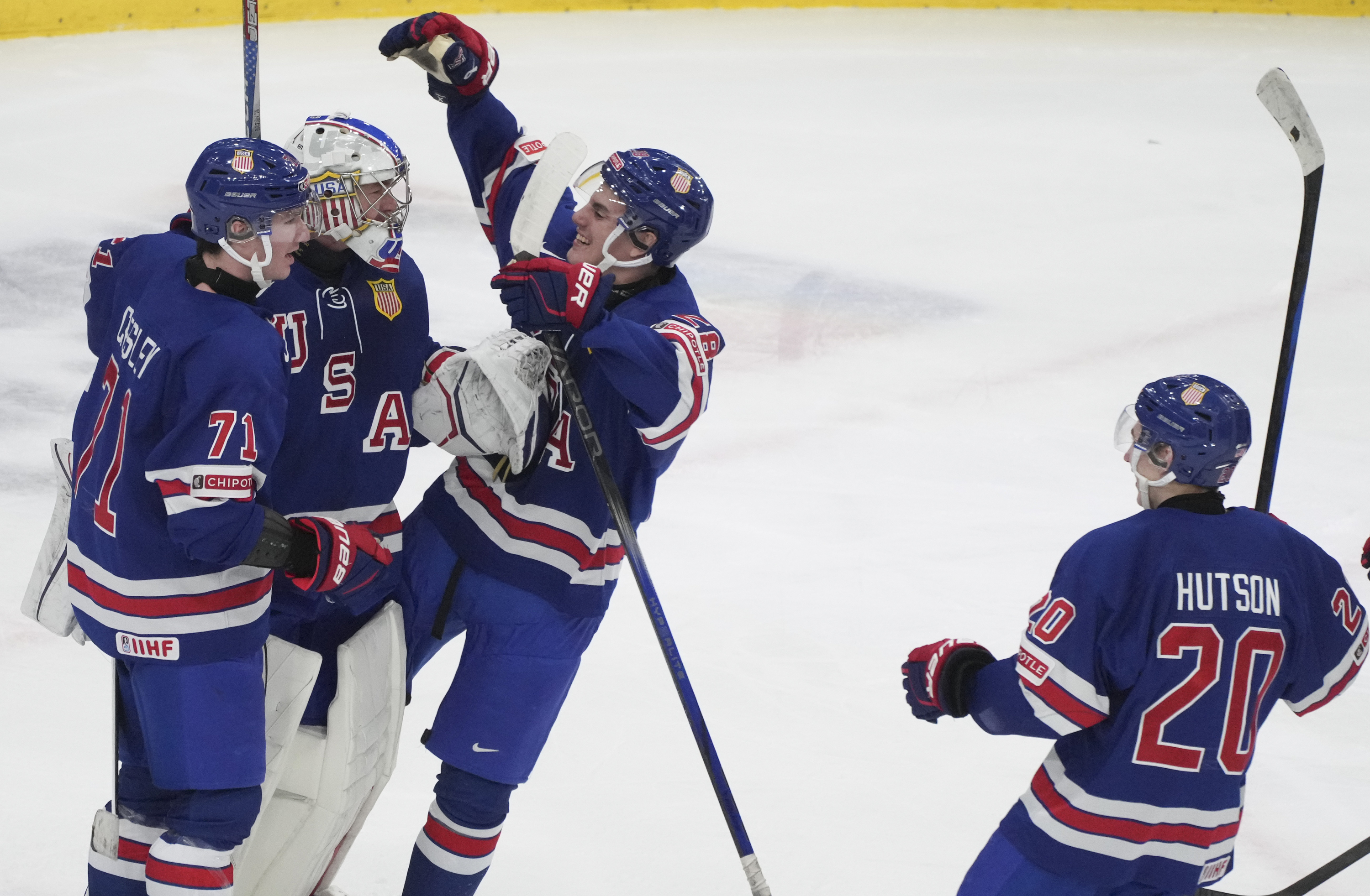 Team USA goaltender Trey Augustine (1) celebrates a win over Finland with teammates Ryan Chesley (71) and Lane Hutson (20) following third-period semifinal game action at the IIHF World Junior Hockey Championship in Gothenburg, Sweden, Thursday, Jan. 4, 2024. 