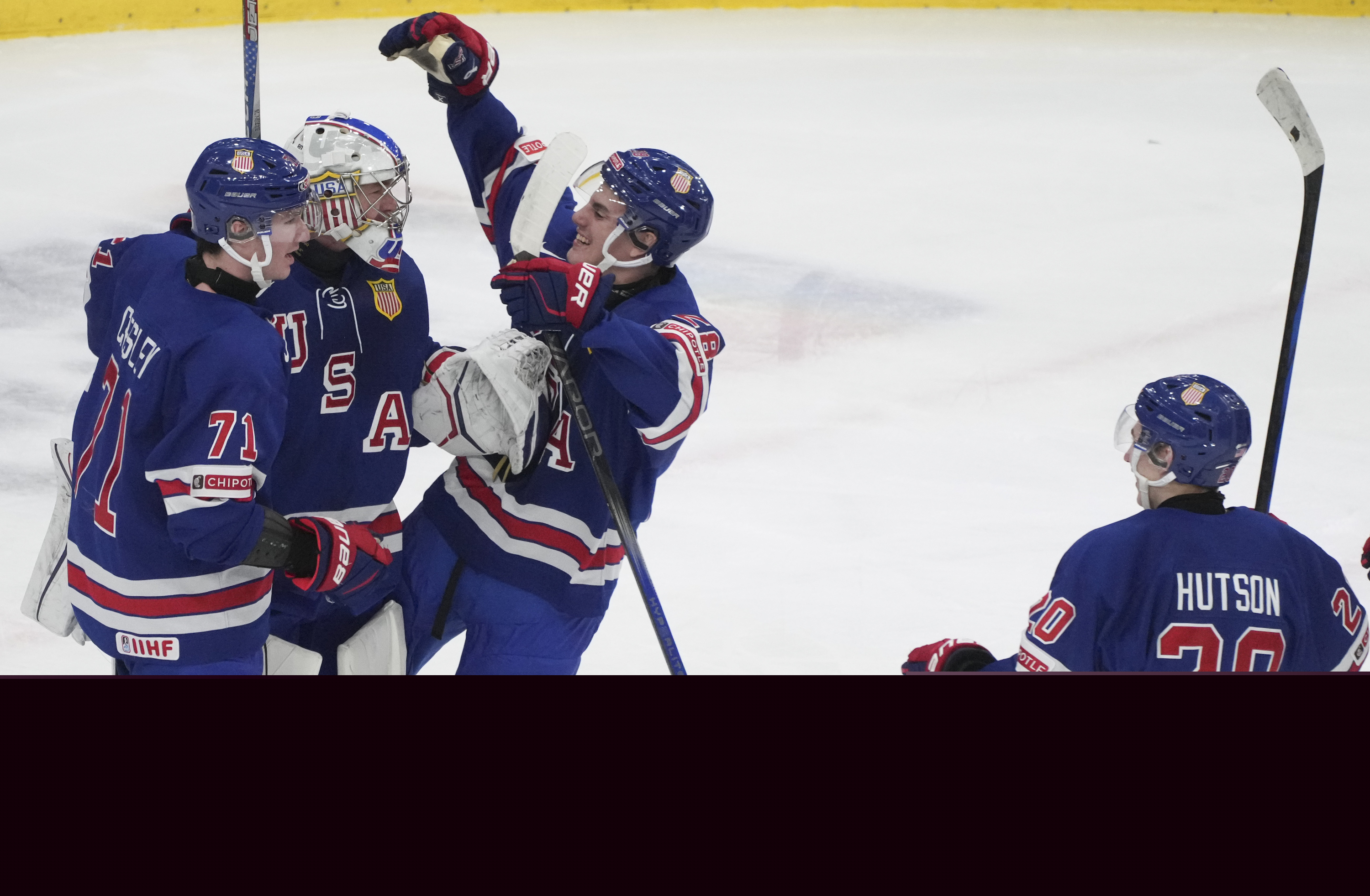 Team USA goaltender Trey Augustine (1) celebrates a win over Finland with teammates Ryan Chesley (71) and Lane Hutson (20) following third-period semifinal game action at the IIHF World Junior Hockey Championship in Gothenburg, Sweden, Thursday, Jan. 4, 2024. 