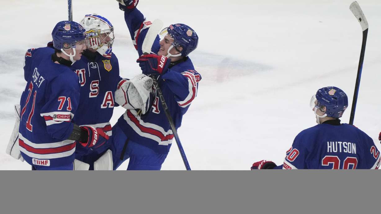 Team USA goaltender Trey Augustine (1) celebrates a win over Finland with teammates Ryan Chesley (71) and Lane Hutson (20) following third-period semifinal game action at the IIHF World Junior Hockey Championship in Gothenburg, Sweden, Thursday, Jan. 4, 2024.