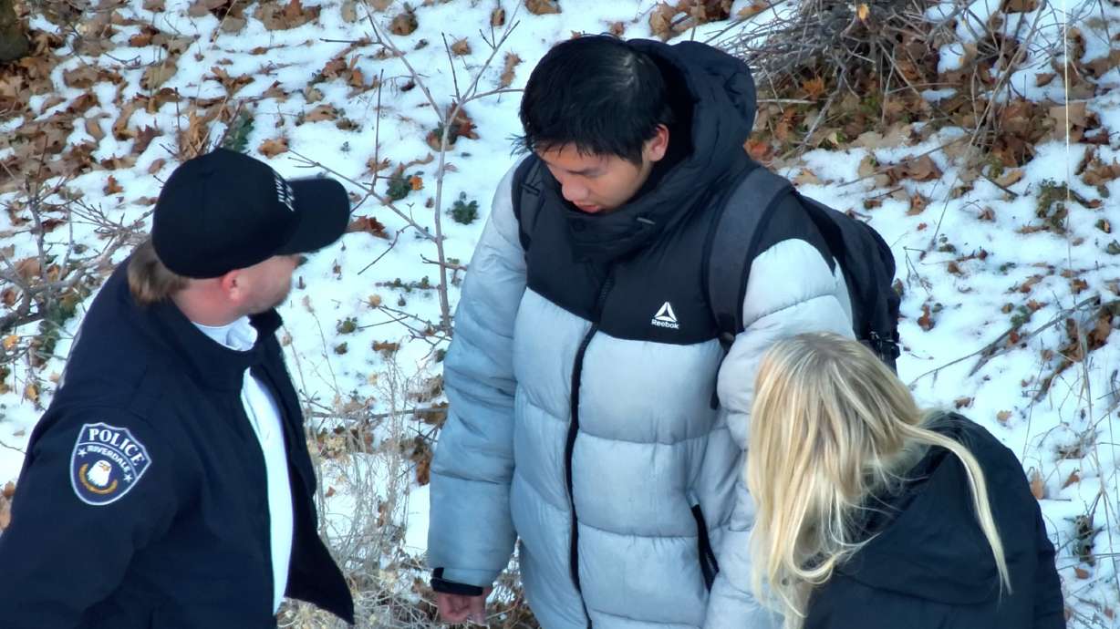 Law enforcement officials talk with Kai Zhuang, a 17-year-old Chinese exchange student, after he was found safe in a tent near Brigham City on Dec. 31, 2023.