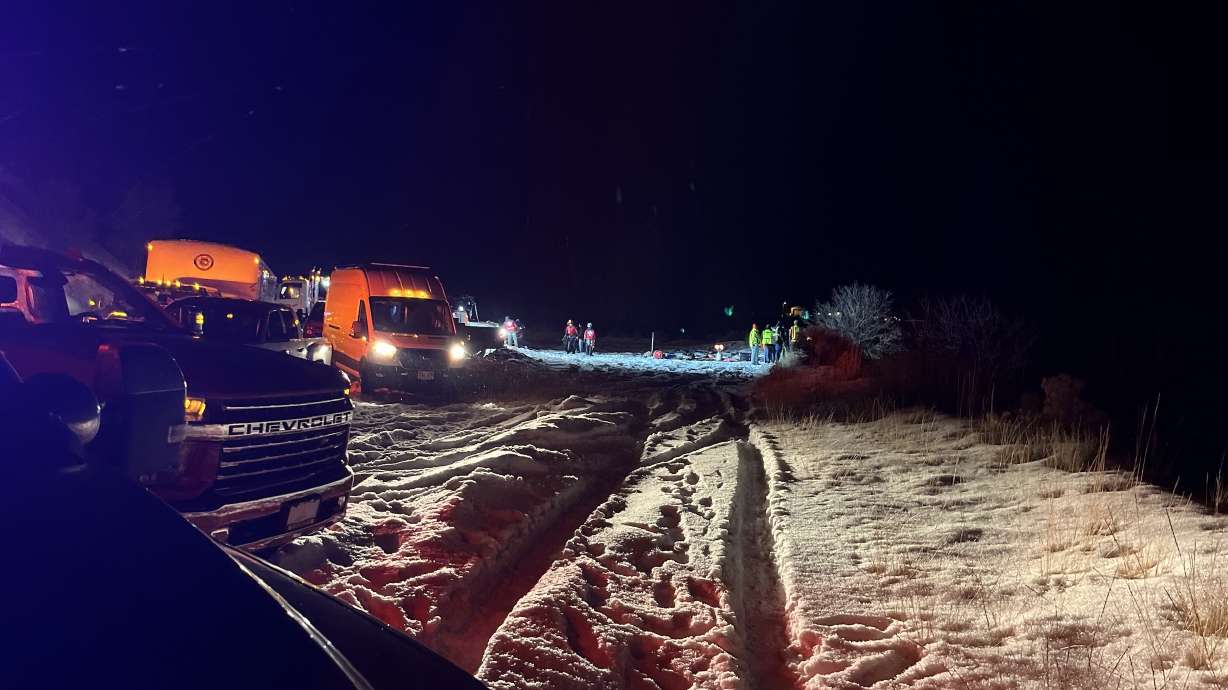 Emergency crews respond to a crash at Pineview Reservoir on Thursday. At least one person died in the crash.