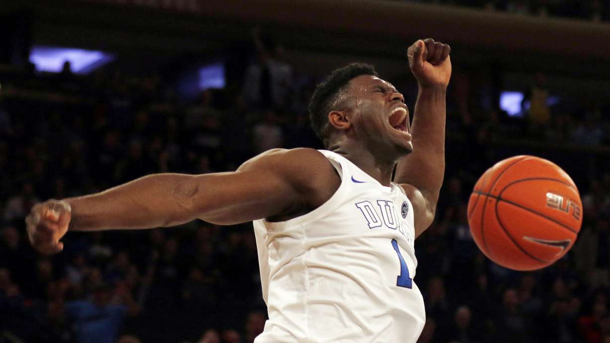 FILE - Duke forward Zion Williamson (1) reacts after a dunk against Texas Tech during the first half of an NCAA college basketball game in New York, Dec. 20, 2018.