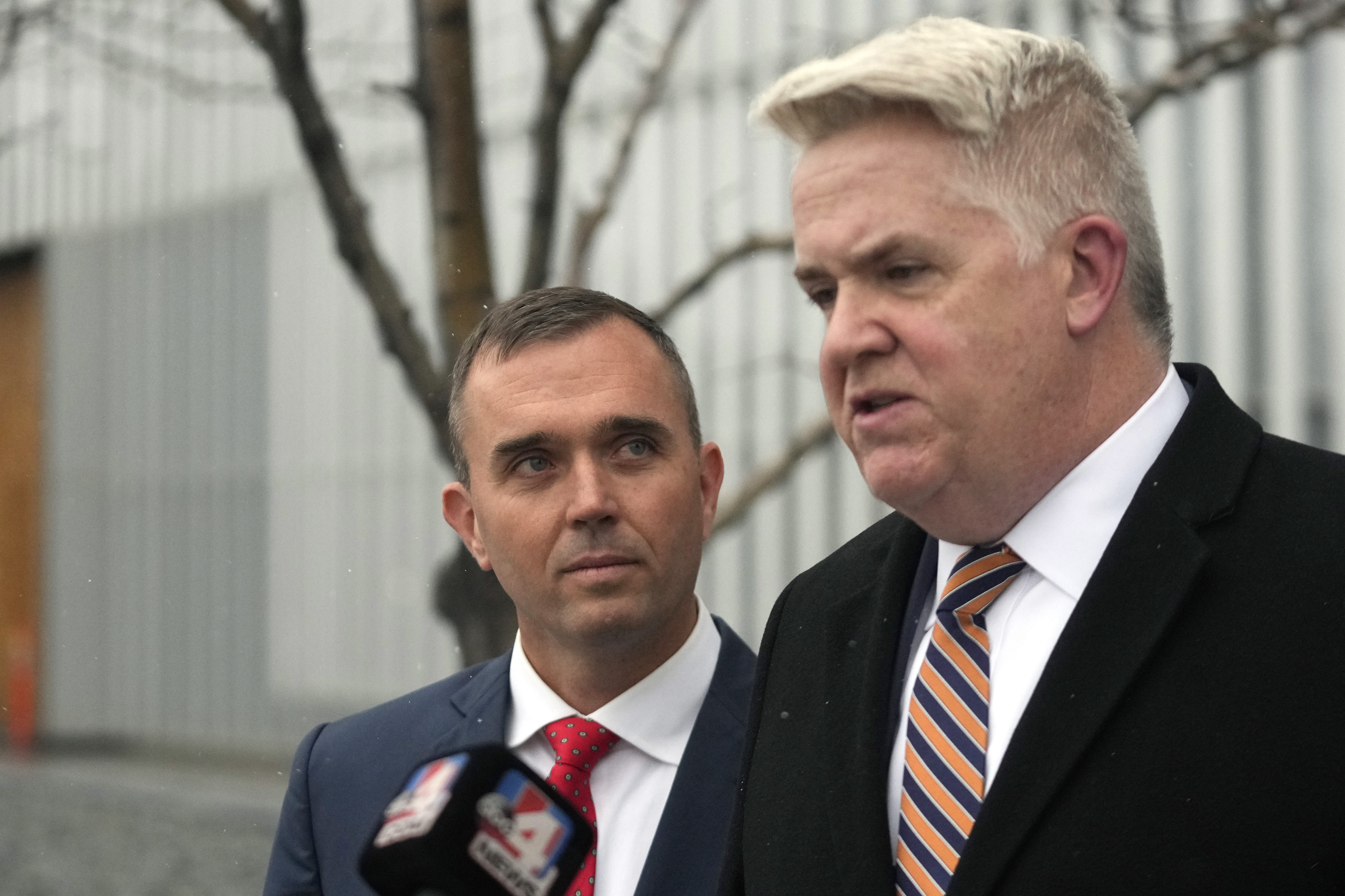 Former pilot Jonathan J. Dunn, left, stands with attorney John Huber following a court appearance Thursday in Salt Lake City. Dunn, who was the co-pilot, is charged with threatening to shoot the captain in the cockpit during a flight to Salt Lake City. 