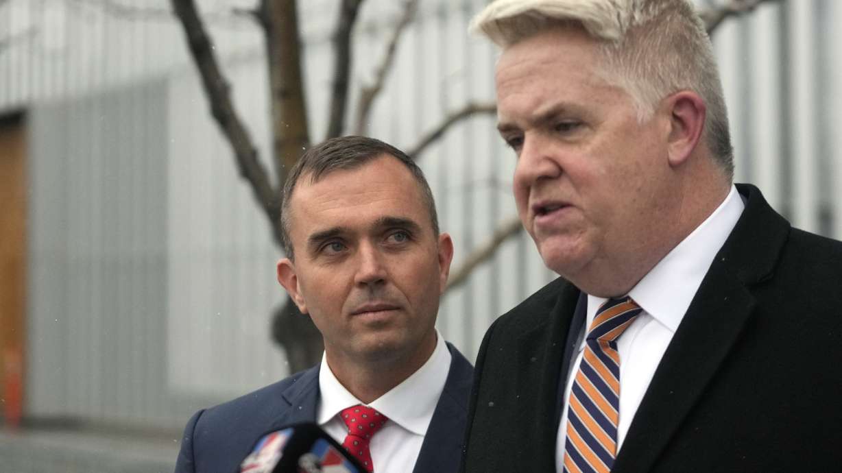 Former pilot Jonathan J. Dunn, left, stands with attorney John Huber following a court appearance Thursday in Salt Lake City. Dunn, who was the co-pilot, is charged with threatening to shoot the captain in the cockpit during a flight to Salt Lake City.