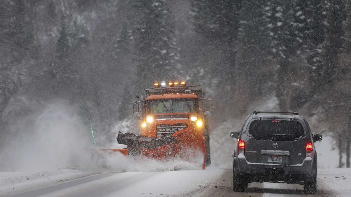 A snowplow clears the road in Big Cottonwood Canyon on Dec. 1, 2023. Schools in Juab and Iron counties on Thursday announced a delayed start, with schools in both counties starting two hours later than usual.
