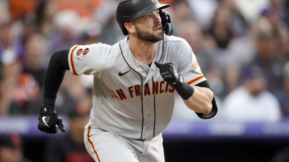 FILE - San Francisco Giants' Mitch Haniger (17) runs down the baseline in the third inning of a baseball game Tuesday, June 6, 2023, in Denver. Haniger returned to the Seattle Mariners when he was acquired from the Giants on Friday, Jan. 5, 2023, with right-hander Anthony DeSclafani and $6 million for left-hander Robbie Ray in a trade of underperforming players coming off injuries.