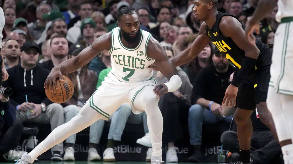 Boston Celtics guard Jaylen Brown (7) sets to drive against Utah Jazz guard Kris Dunn (11) during the first half of an NBA basketball game, Friday, Jan. 5, 2024, in Boston.
