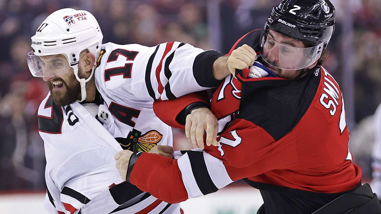 Chicago Blackhawks left wing Nick Foligno (17) fights with New Jersey Devils defenseman Brendan Smith during the second period of an NHL hockey game Friday, Jan. 5, 2024, in Newark, N.J.
