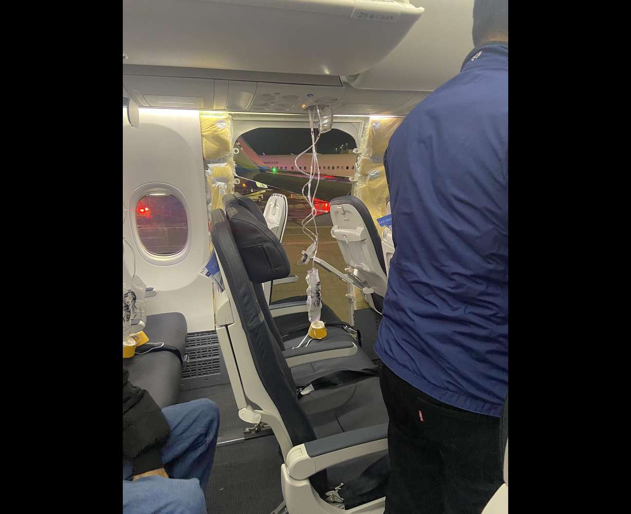 An Alaska Airlines flight made an emergency landing in Oregon on Friday after a window and chunk of its fuselage blew out in midair, media reports said.
