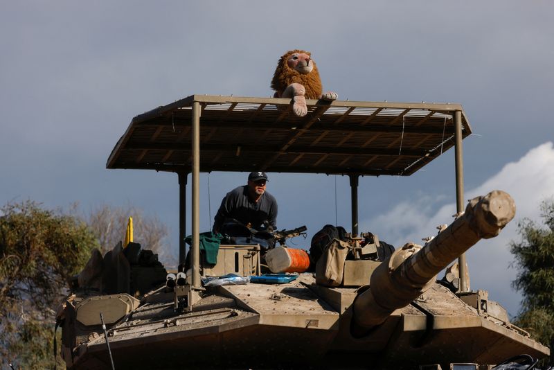 A man works on a tank near the border with northern Gaza, amid the ongoing conflict between Israel and the Palestinian Islamist group Hamas, Friday. 