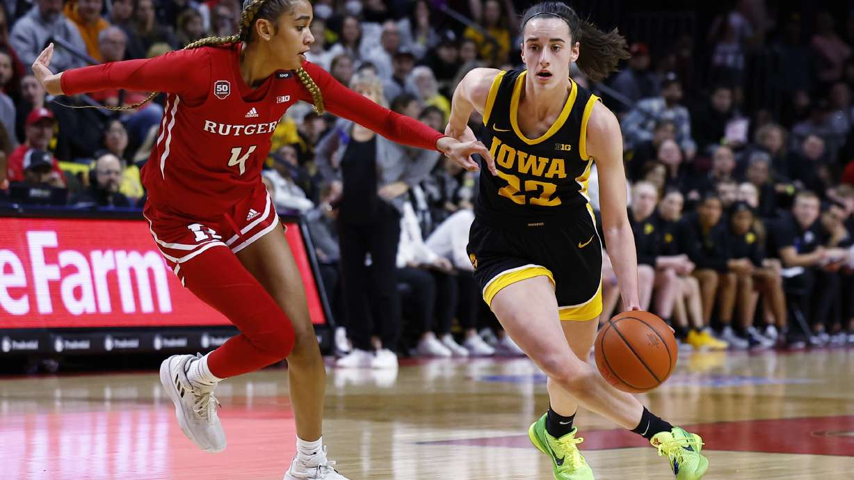 Iowa guard Caitlin Clark (22) drives to the basket against Rutgers guard Antonia Bates (4) during the first half of an NCAA college basketball game Friday, Jan. 5, 2024, in Piscataway, N.J.