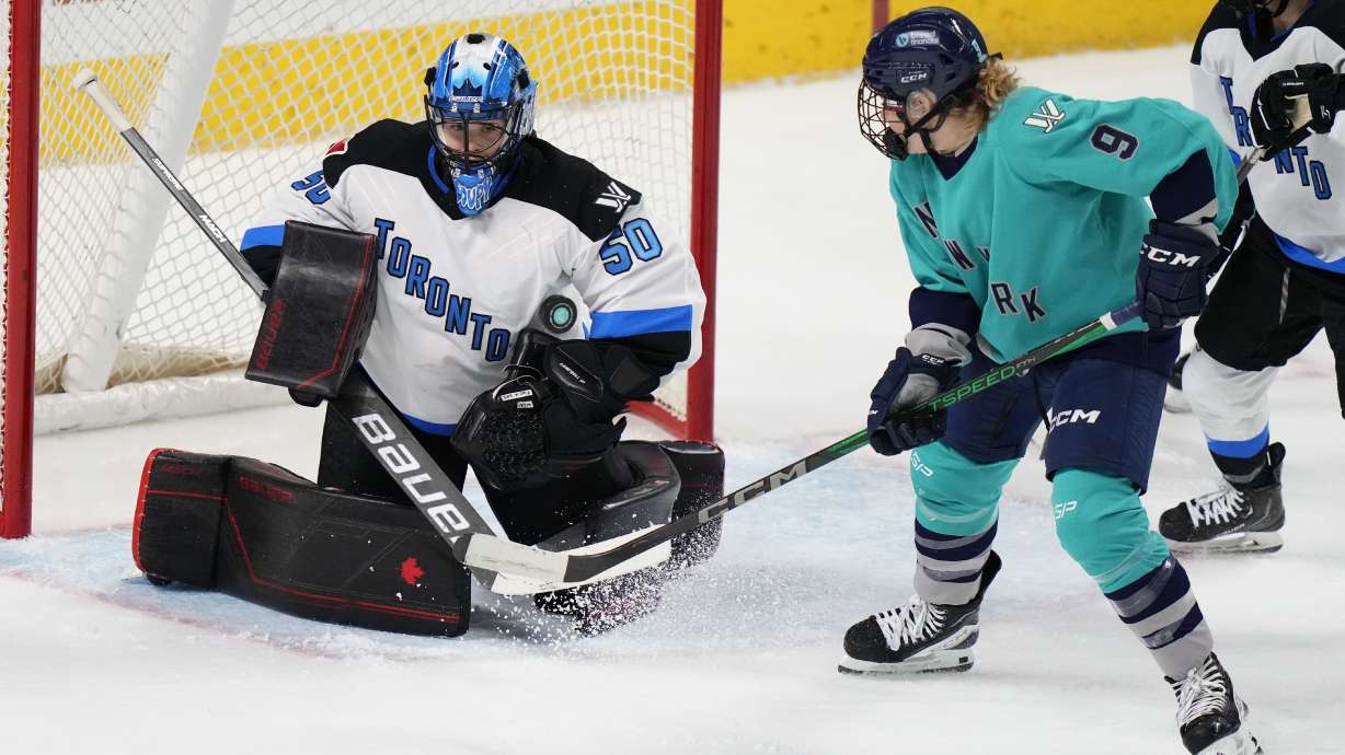 New York's Jessie Eldridge (9) watches as Toronto goaltender Kristen Campbell (50) stops a shot during the second period of a PWHL hockey game Friday, Jan. 5, 2024, in Bridgeport, Conn.