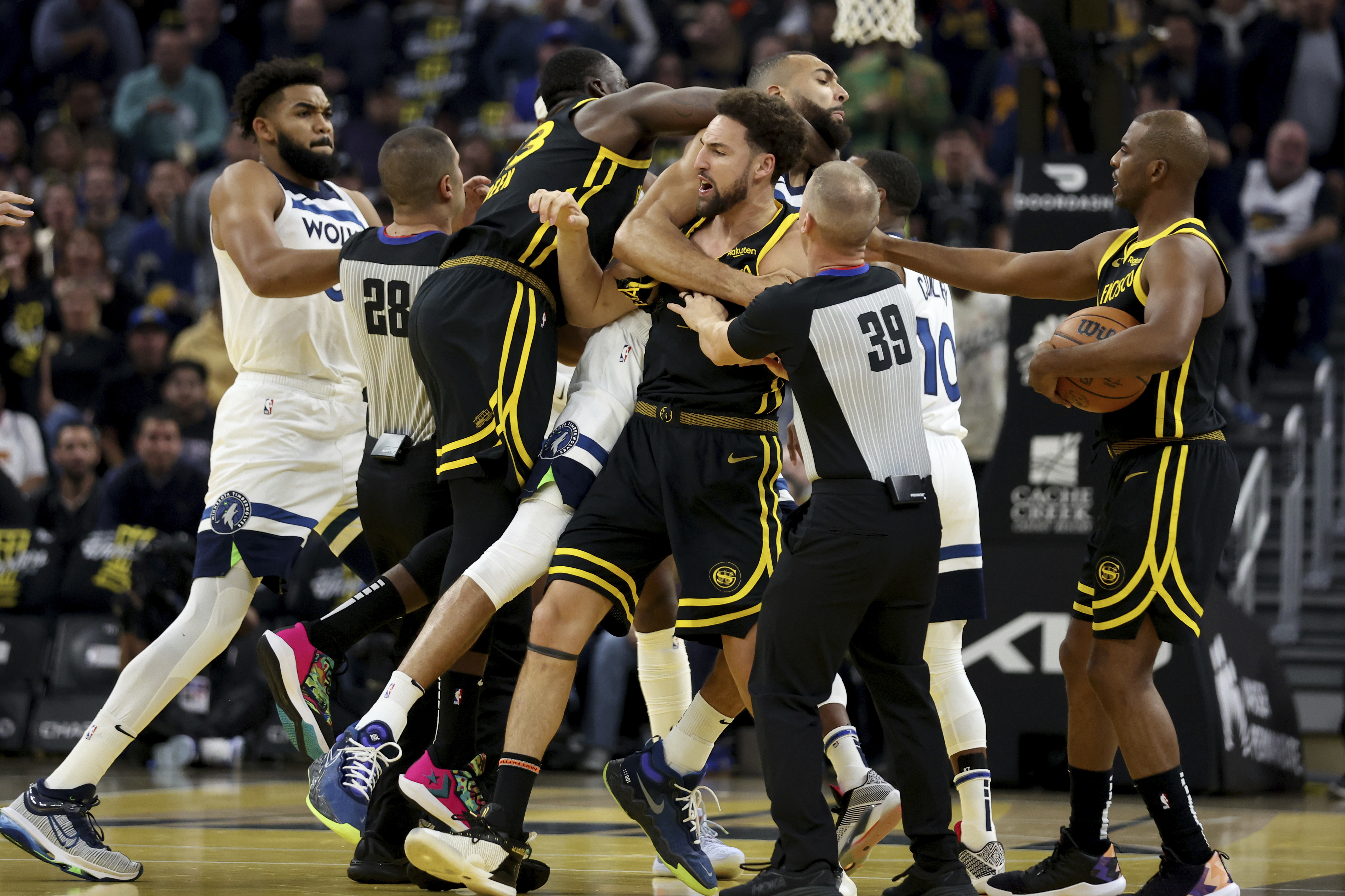 FILE - Golden State Warriors guard Klay Thompson, front, and Draymond Green, left, gets into an altercation with Minnesota Timberwolves center Rudy Gobert, back, during the first half of an in-season NBA tournament basketball game in San Francisco, Nov. 14, 2023. Green has been suspended indefinitely by the NBA on Wednesday, Dec. 13. 