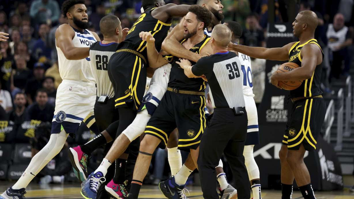 FILE - Golden State Warriors guard Klay Thompson, front, and Draymond Green, left, gets into an altercation with Minnesota Timberwolves center Rudy Gobert, back, during the first half of an in-season NBA tournament basketball game in San Francisco, Nov. 14, 2023. Green has been suspended indefinitely by the NBA on Wednesday, Dec. 13.