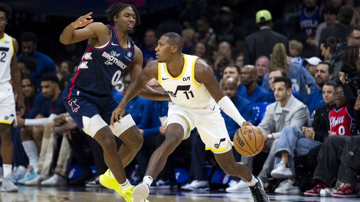 Utah Jazz's Kris Dunn, right, looks to make a move against Philadelphia 76ers' Tyrese Maxey during the the first half of an NBA basketball game Saturday, Jan. 6, 2024, in Philadelphia.