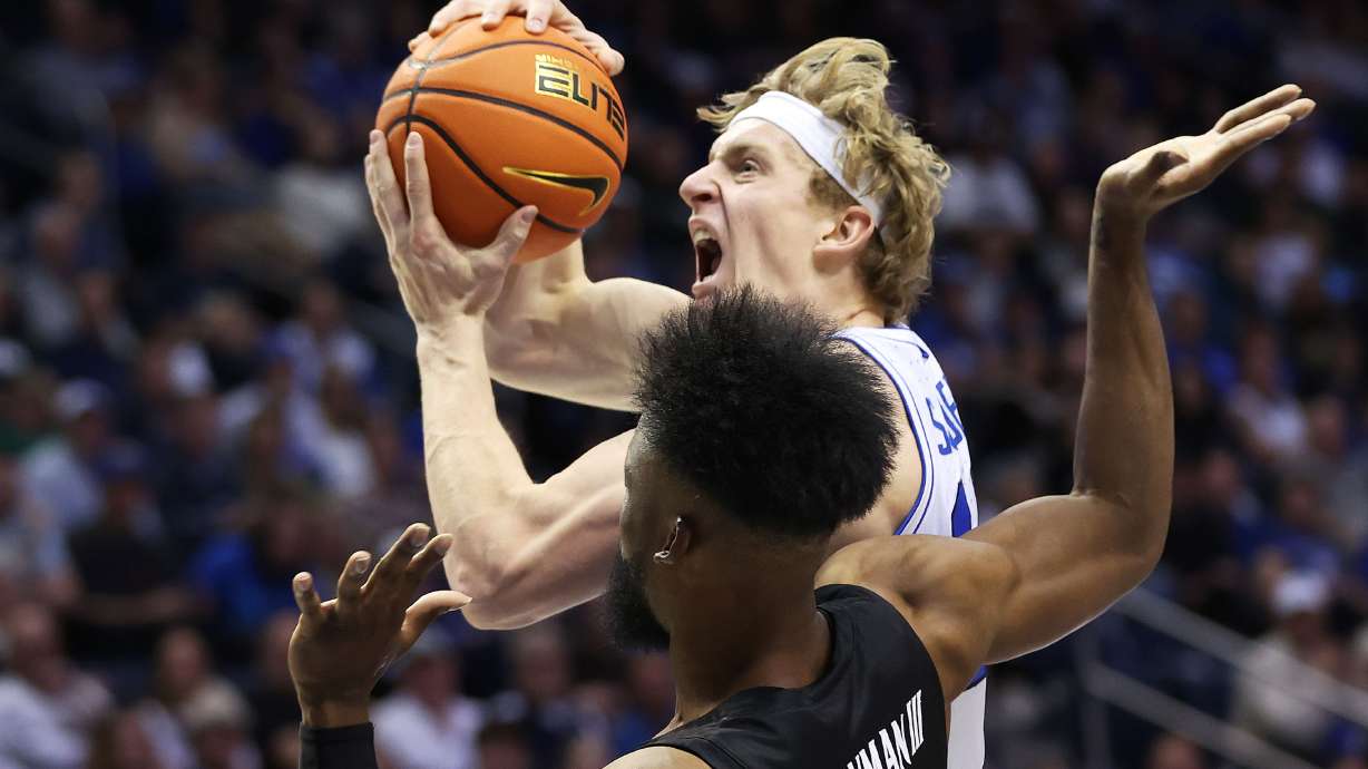 Brigham Young Cougars guard Richie Saunders (15) drives on Cincinnati Bearcats forward John Newman III (15) in Provo on Saturday, Jan. 6, 2024. Cincinnati won 71-60.
