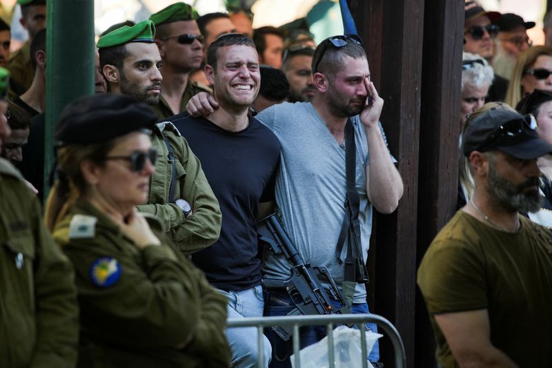 Friends and family mourn Lieutenant Colonel Roee Yohay Yosef Mordechay, 31, killed in northern Gaza during the ongoing ground operation by Israel's military in the Gaza Strip, amid the ongoing conflict between Israel and the Palestinian Islamist group Hamas, at his funeral in Tel Aviv, Israel, Jan. 7.