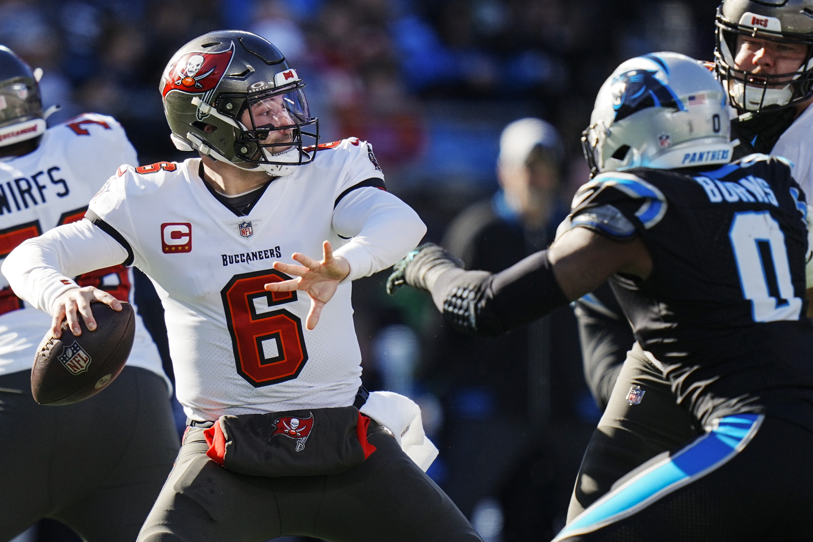 Tampa Bay Buccaneers quarterback Baker Mayfield (6) works in the pocket as Carolina Panthers linebacker Brian Burns (0) defends during the first half of an NFL football game, Sunday, Jan. 7, 2024, in Charlotte, N.C.