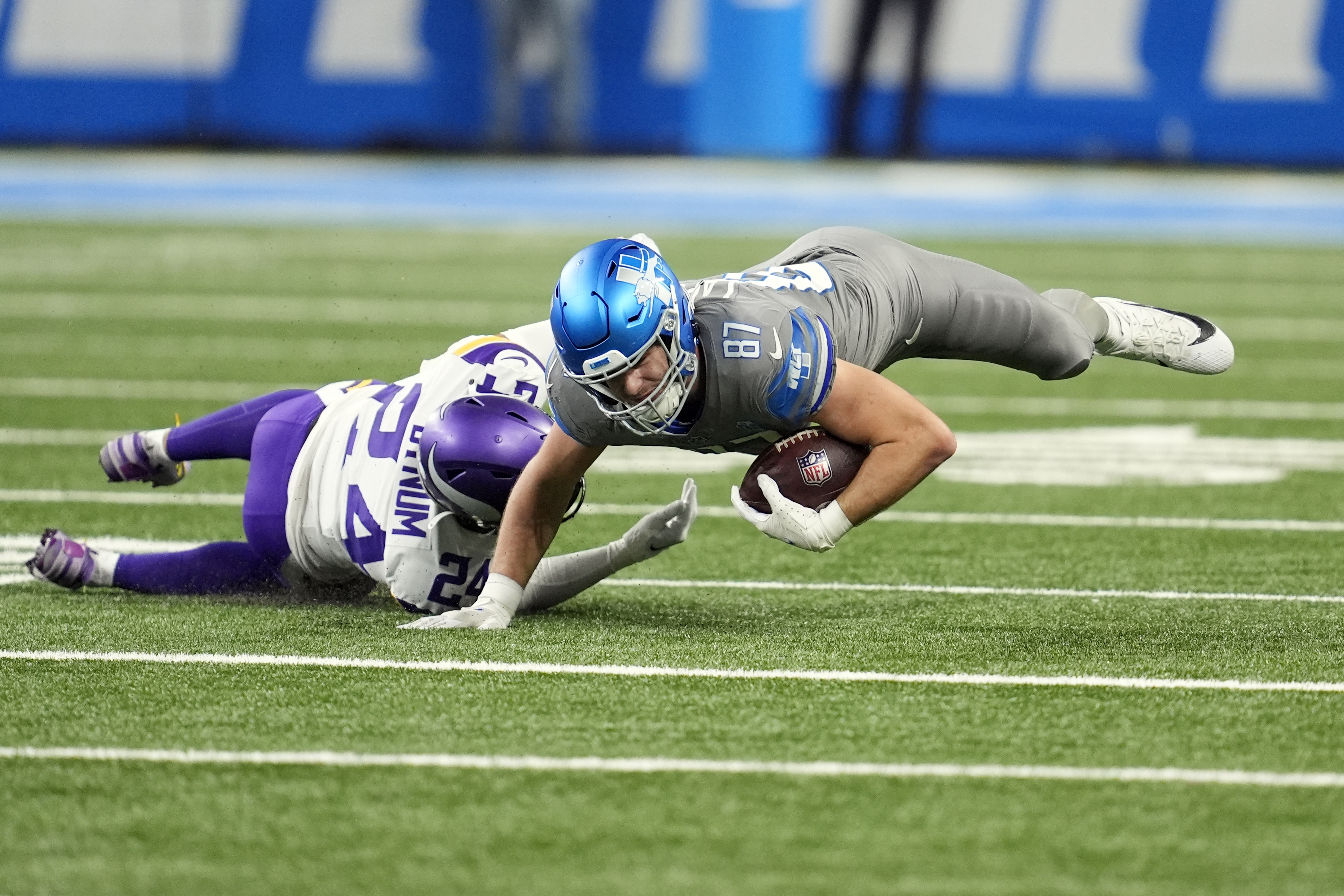 Detroit Lions tight end Sam LaPorta (87) is tackled by Minnesota Vikings safety Camryn Bynum during the first half of an NFL football game, Sunday, Jan. 7, 2024, in Detroit. 