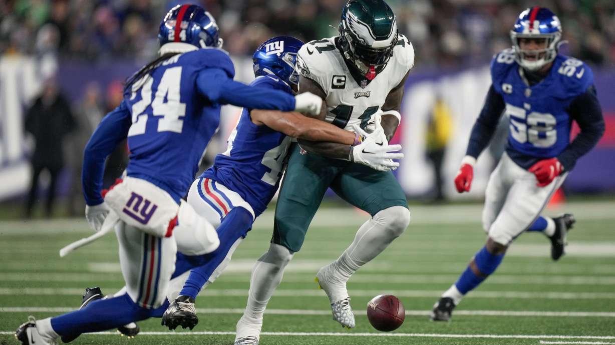 New York Giants cornerback Nick McCloud (44) forces a fumble on Philadelphia Eagles wide receiver A.J. Brown (11) during the first quarter of an NFL football game, Sunday, Jan. 7, 2024, in East Rutherford, N.J.