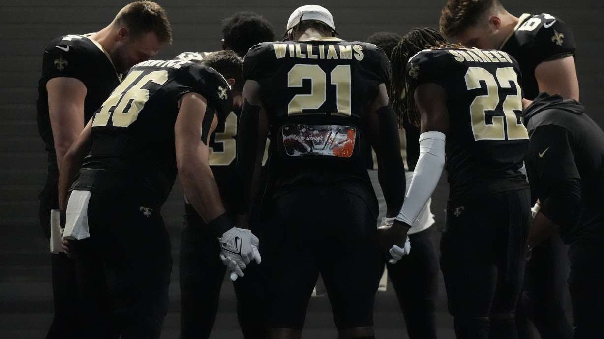 New Orleans Saints players huddle in a tunnel before an NFL football game against the Atlanta Falcons in New Orleans, Sunday, Jan. 7, 2024.