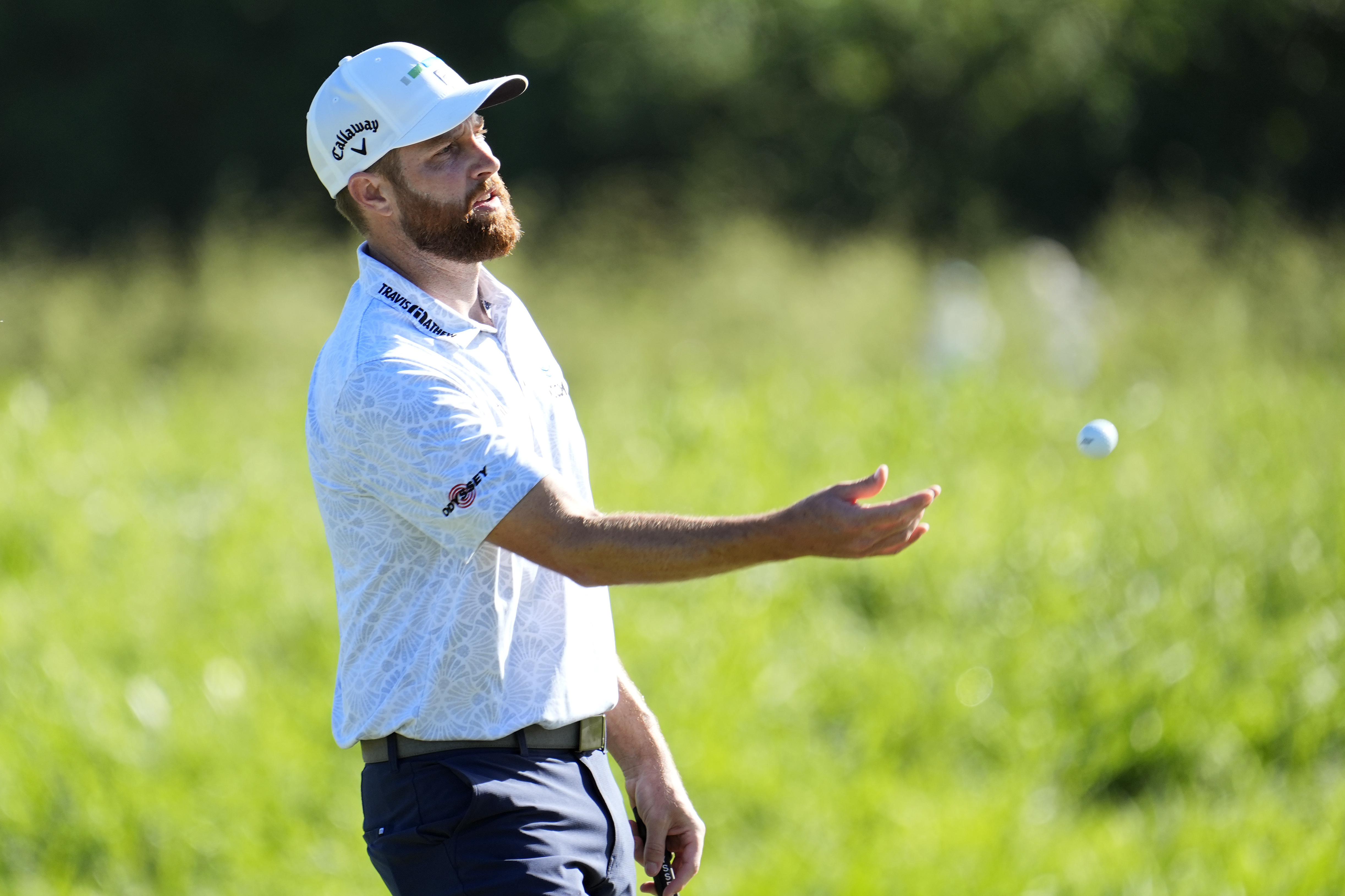 Chris Kirk tosses his ball to his caddy on the second green during the final round of The Sentry golf event, Sunday, Jan. 7, 2024, at Kapalua Plantation Course in Kapalua, Hawaii. 