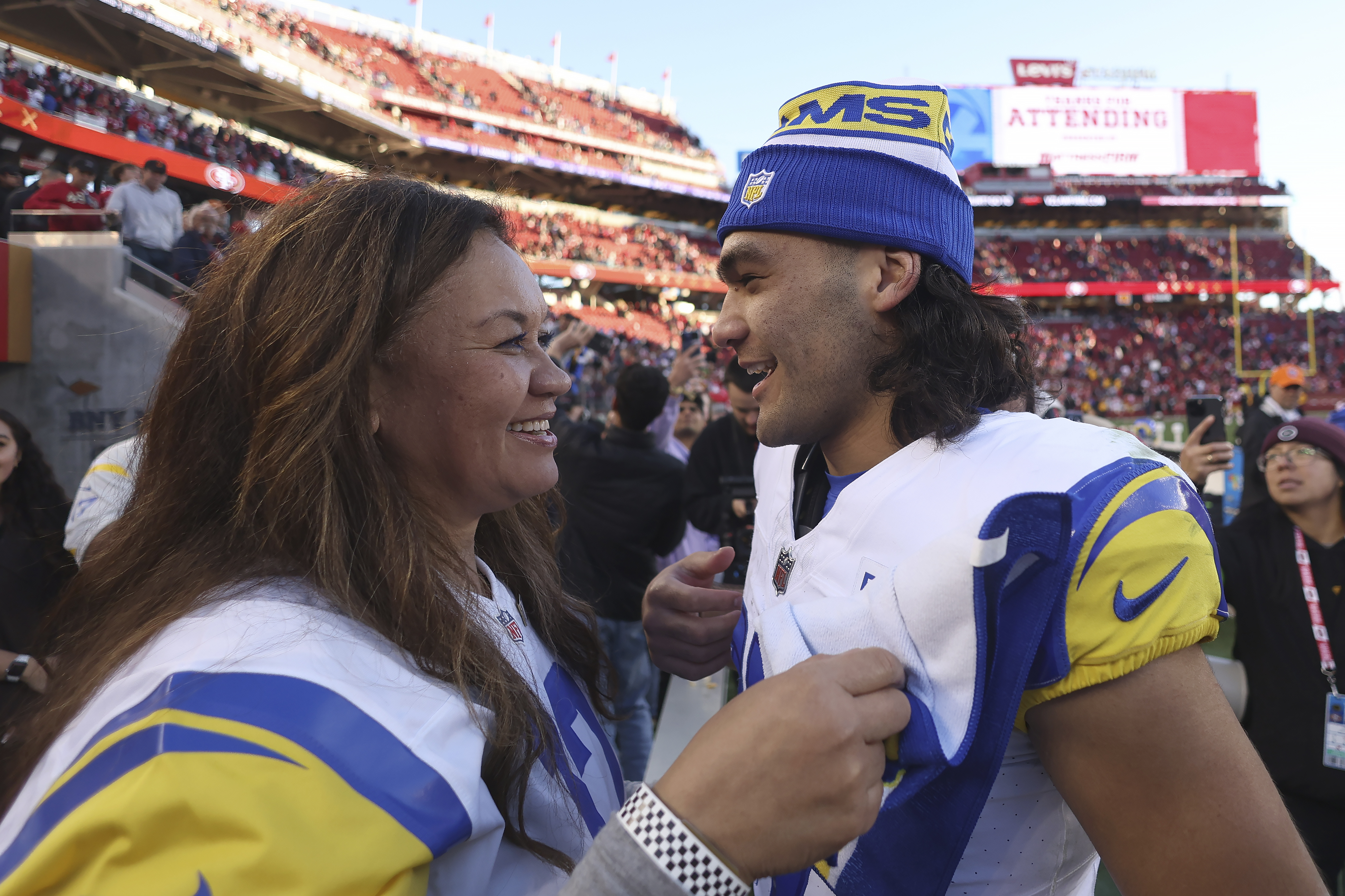 Los Angeles Rams wide receiver Puka Nacua, right, talks with his mother, Penina Nacua, after the Rams defeated the San Francisco 49ers in an NFL football game in Santa Clara, Calif., Sunday, Jan. 7, 2024.