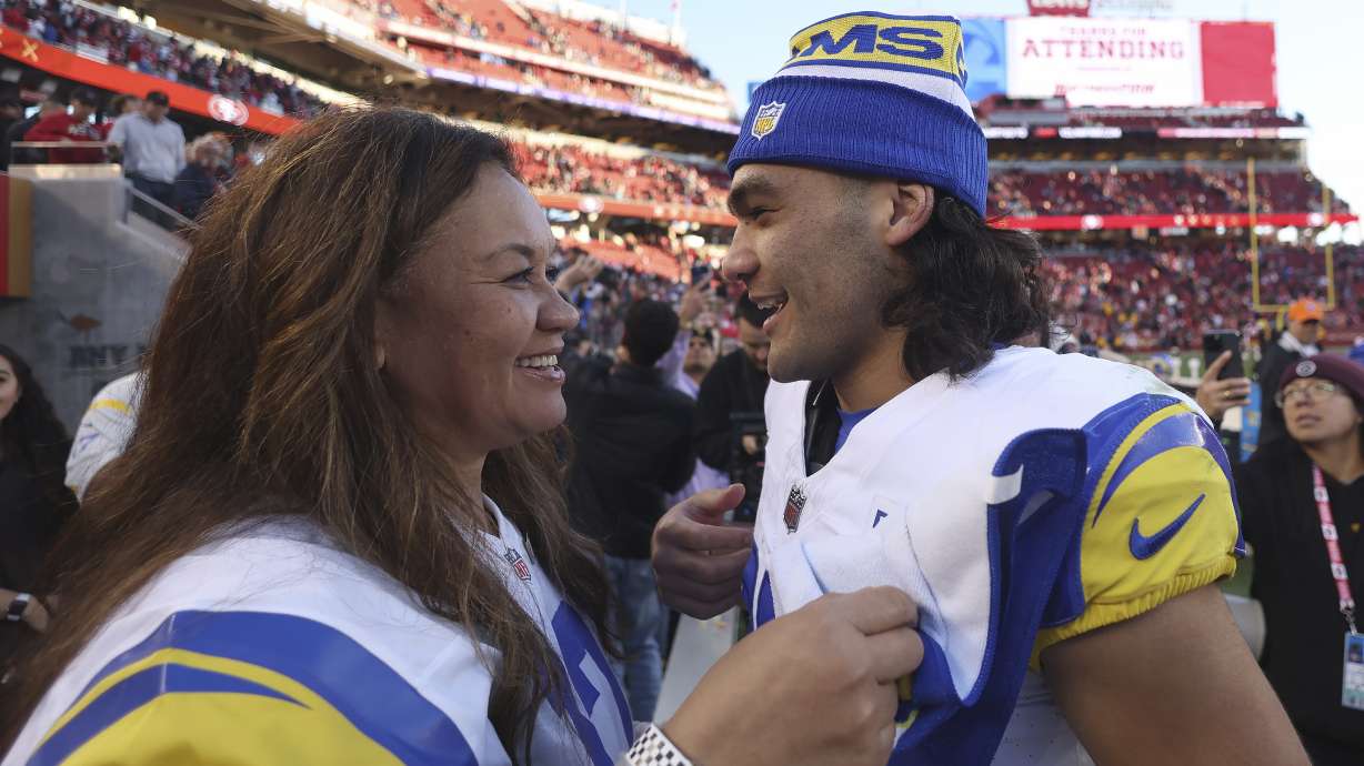 Los Angeles Rams wide receiver Puka Nacua, right, talks with his mother, Penina Nacua, after the Rams defeated the San Francisco 49ers in an NFL football game in Santa Clara, Calif., Sunday, Jan. 7, 2024.