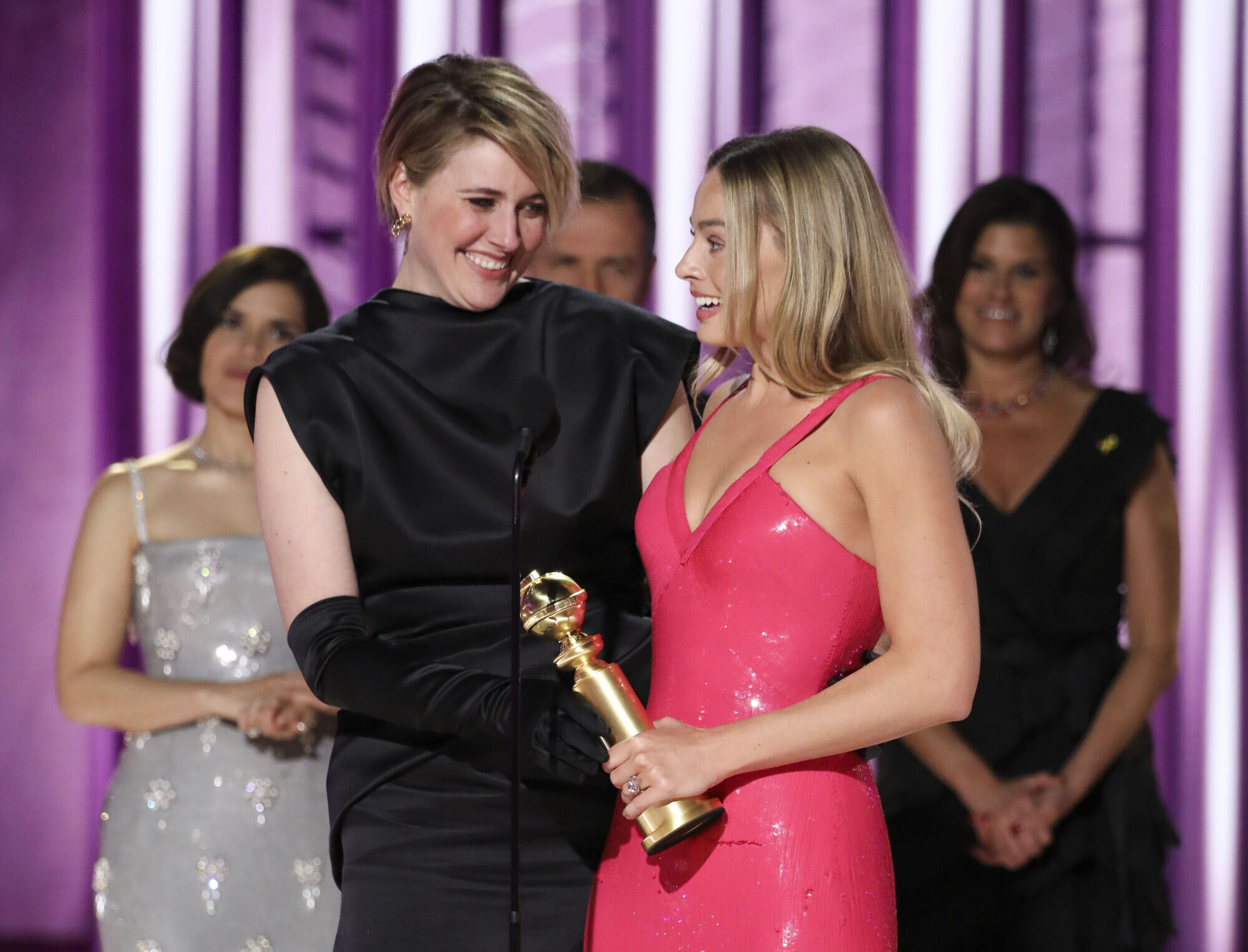This image released by CBS shows co-director Greta Gerwig, left, and actor Margot Robbie accepting the award for best cinematic and box office achievement for the film "Barbie" during the 81st Annual Golden Globe Awards in Beverly Hills, Calif., on Sunday.