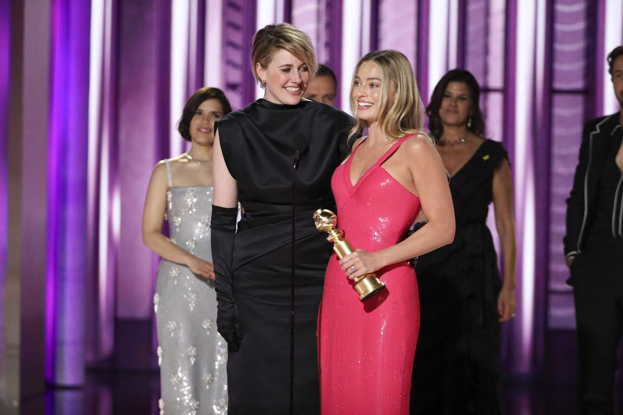 This image released by CBS shows co-director Greta Gerwig, left, and actor Margot Robbie accepting the award for best cinematic and box office achievement for the film "Barbie" during the 81st Annual Golden Globe Awards in Beverly Hills, Calif., on Sunday.
