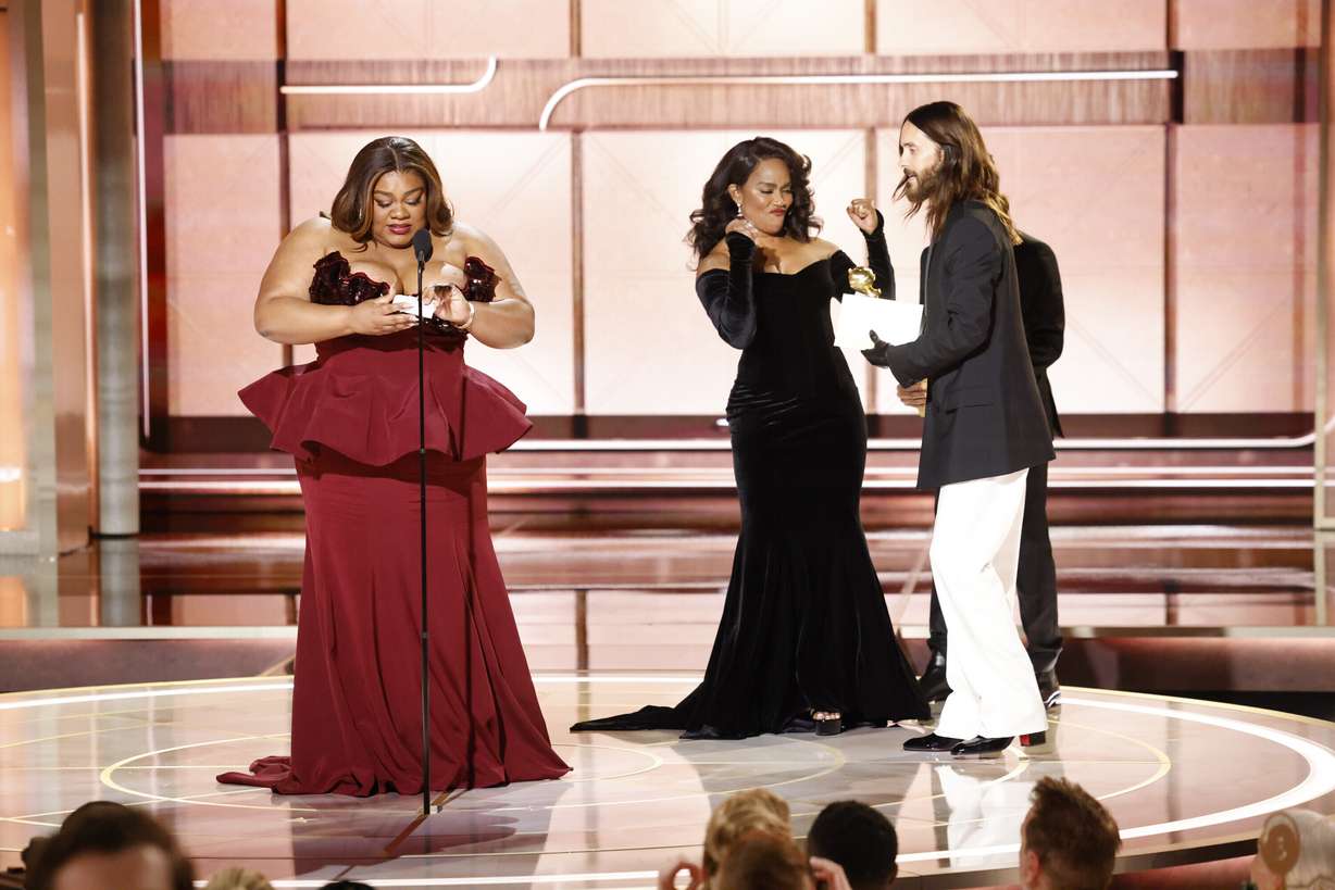 This image released by CBS shows host Da'Vine Joy Randolph, left, accepting the award for best female supporting actor in a motion picture for her role in "The Holdovers" during the 81st Annual Golden Globe Awards in Beverly Hills, Calif., on Sunday. At right are presenters Angela Basset and Jared Leto.