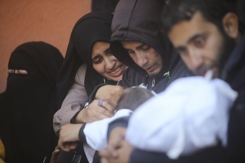 Palestinians mourn for relatives killed in the Israeli bombardment of the Gaza Strip outside a morgue in Khan Younis on Sunday.