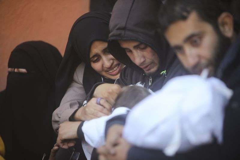 Palestinians mourn for relatives killed in the Israeli bombardment of the Gaza Strip outside a morgue in Khan Younis on Sunday.