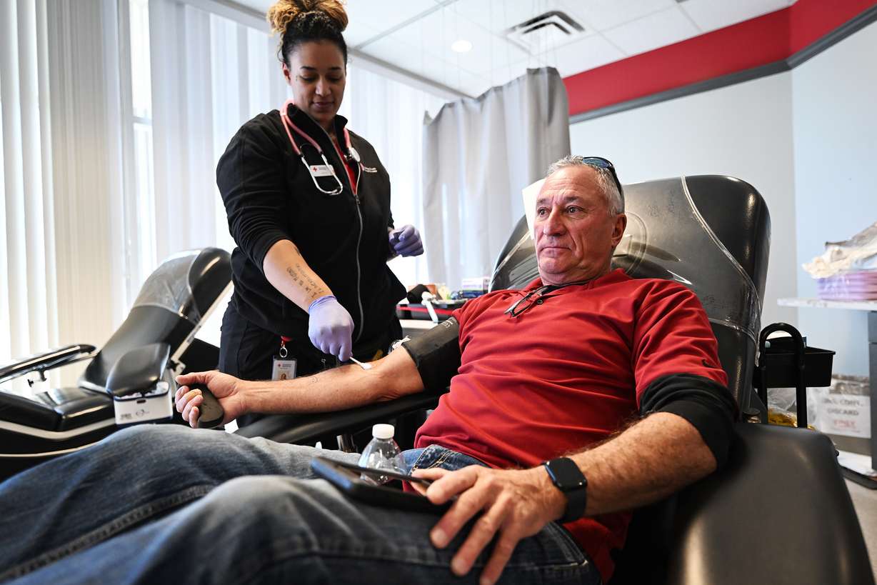 Dennis Druce is assisted in his blood donation by technician Shea Proctor at the American Red Cross Murray location on Monday.