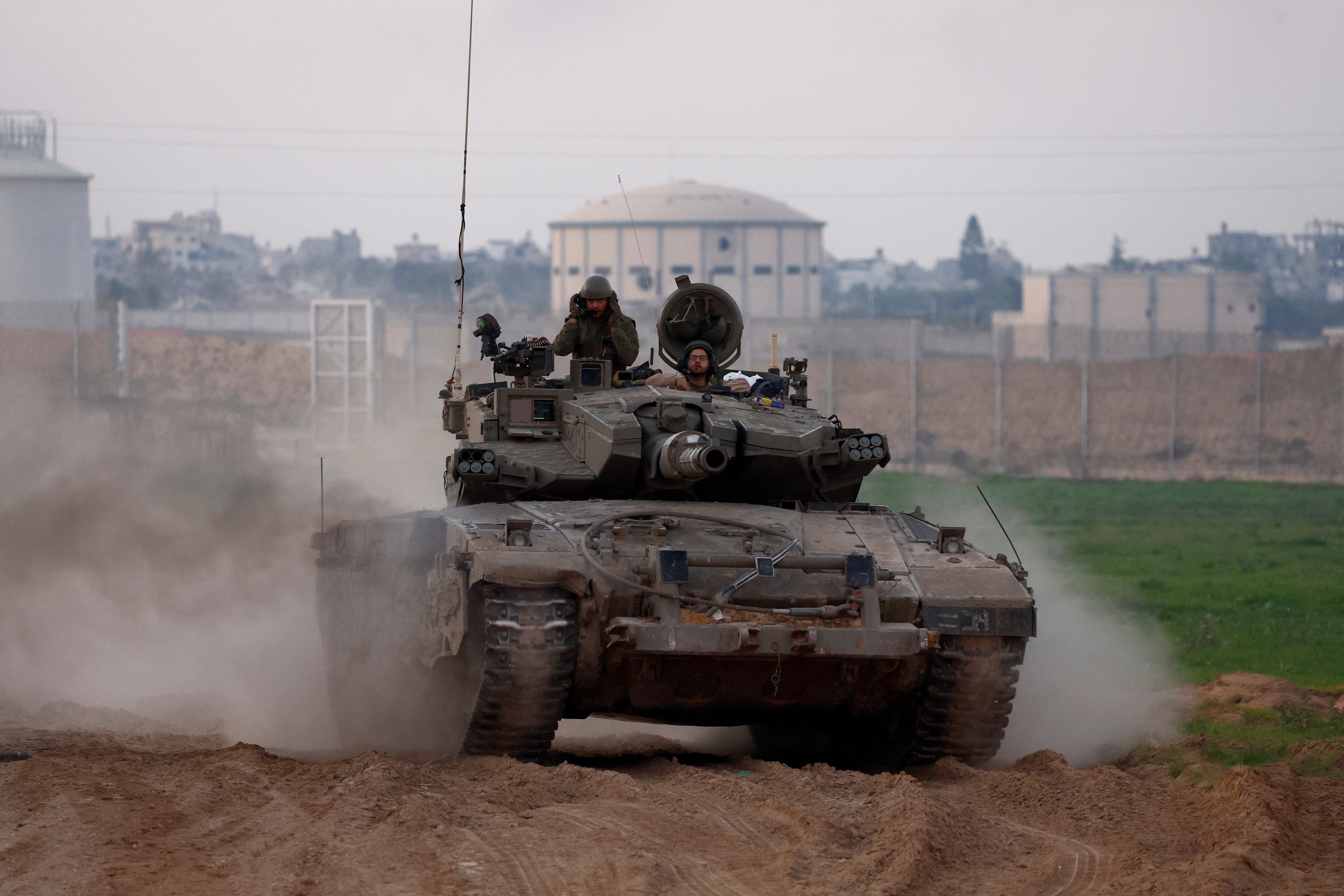 An Israeli tank enters Israel from Gaza, amid the ongoing conflict between Israel and the Palestinian Islamist group Hamas, at the Israel-Gaza border, Israel, Saturday.