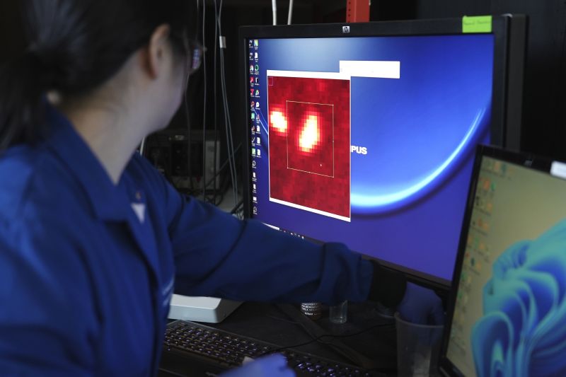 Naixin Qian, a Columbia physical chemist, zooms in on an image generated from a microscope scan, with nanoplastics, microscopic plastic pieces, appearing as bright red dots in New York on Monday.