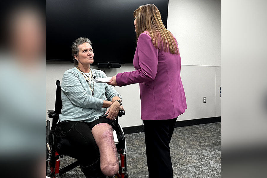 Debbie Crawley and hospital spokeswoman Coleen Niemann speak to coordinate a reunion for Crawley and the medical personnel that helped save her life.