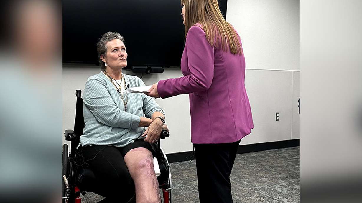 Debbie Crawley and hospital spokeswoman Coleen Niemann speak to coordinate a reunion for Crawley and the medical personnel that helped save her life.