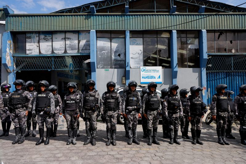 Police officers stand in formation outside El Inca prison after a security operation due to riots in Quito, Ecuador, Monday.