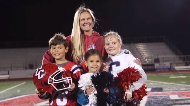 Melanie Fox with Coco, Charlie and Cambry Fox at Crimson Cliffs High School's memorial night for their father and her husband, Mike Fox, who died suddenly on Thanksgiving Day.