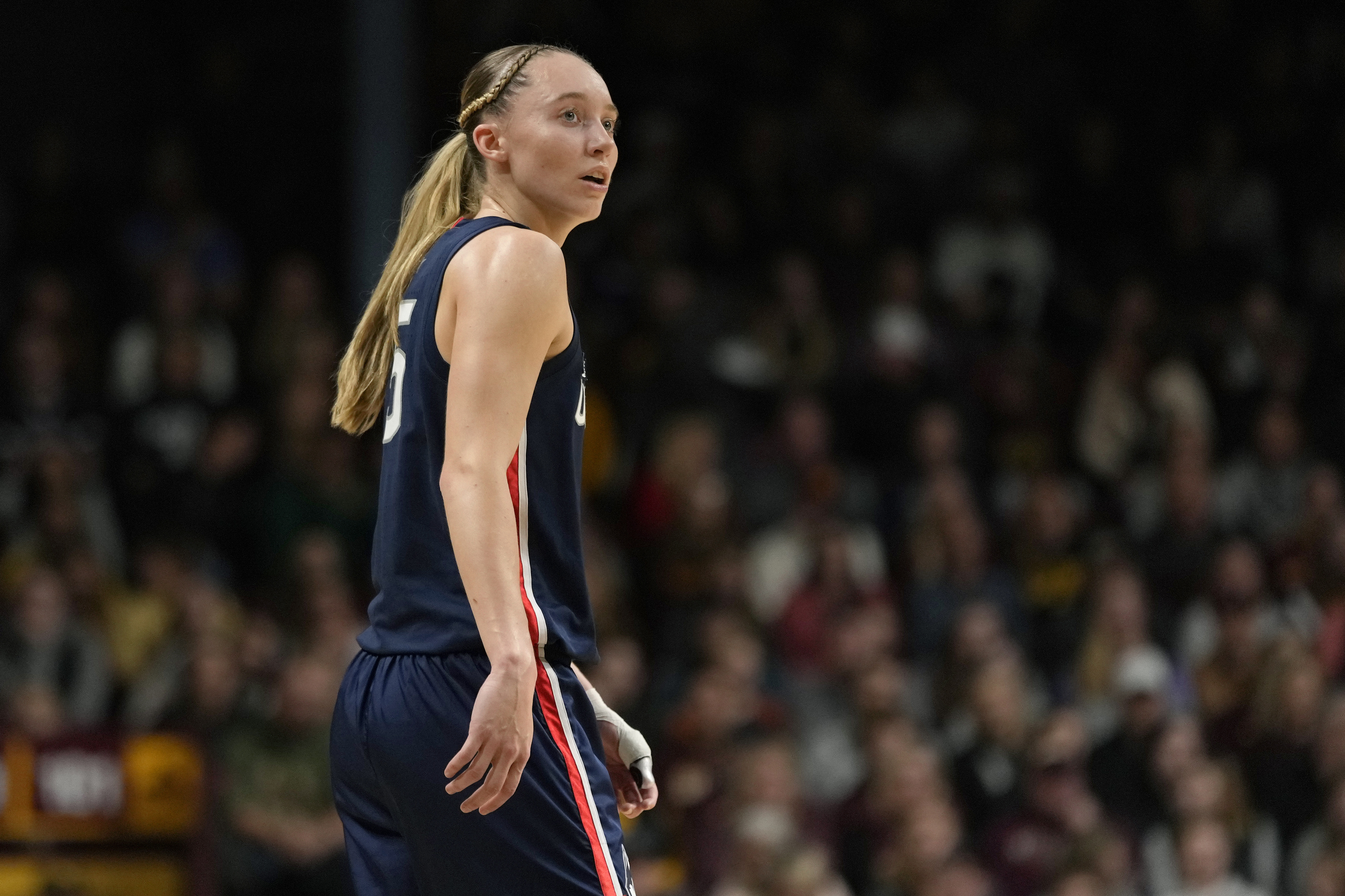 FILE - UConn guard Paige Bueckers (5) stands on the court during the first half of an NCAA college basketball game against Minnesota, Nov. 19, 2023, in Minneapolis. Bueckers, who missed much of the past two seasons with her own injuries, is expected to be a top pick in the WNBA draft, should she choose not to return to school. But she said Tuesday, Jan. 9, 2024, that the "deciding factor" may be her desire for more time and experiences with her college teammates. 