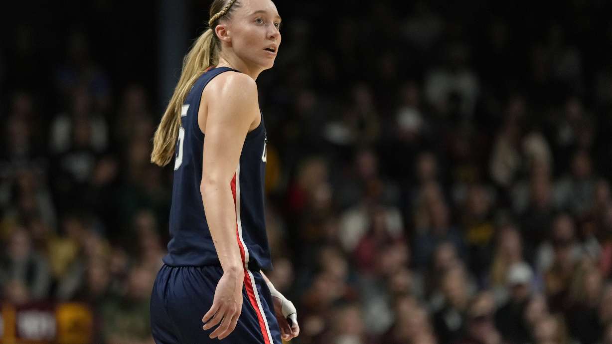 FILE - UConn guard Paige Bueckers (5) stands on the court during the first half of an NCAA college basketball game against Minnesota, Nov. 19, 2023, in Minneapolis. Bueckers, who missed much of the past two seasons with her own injuries, is expected to be a top pick in the WNBA draft, should she choose not to return to school. But she said Tuesday, Jan. 9, 2024, that the "deciding factor" may be her desire for more time and experiences with her college teammates.