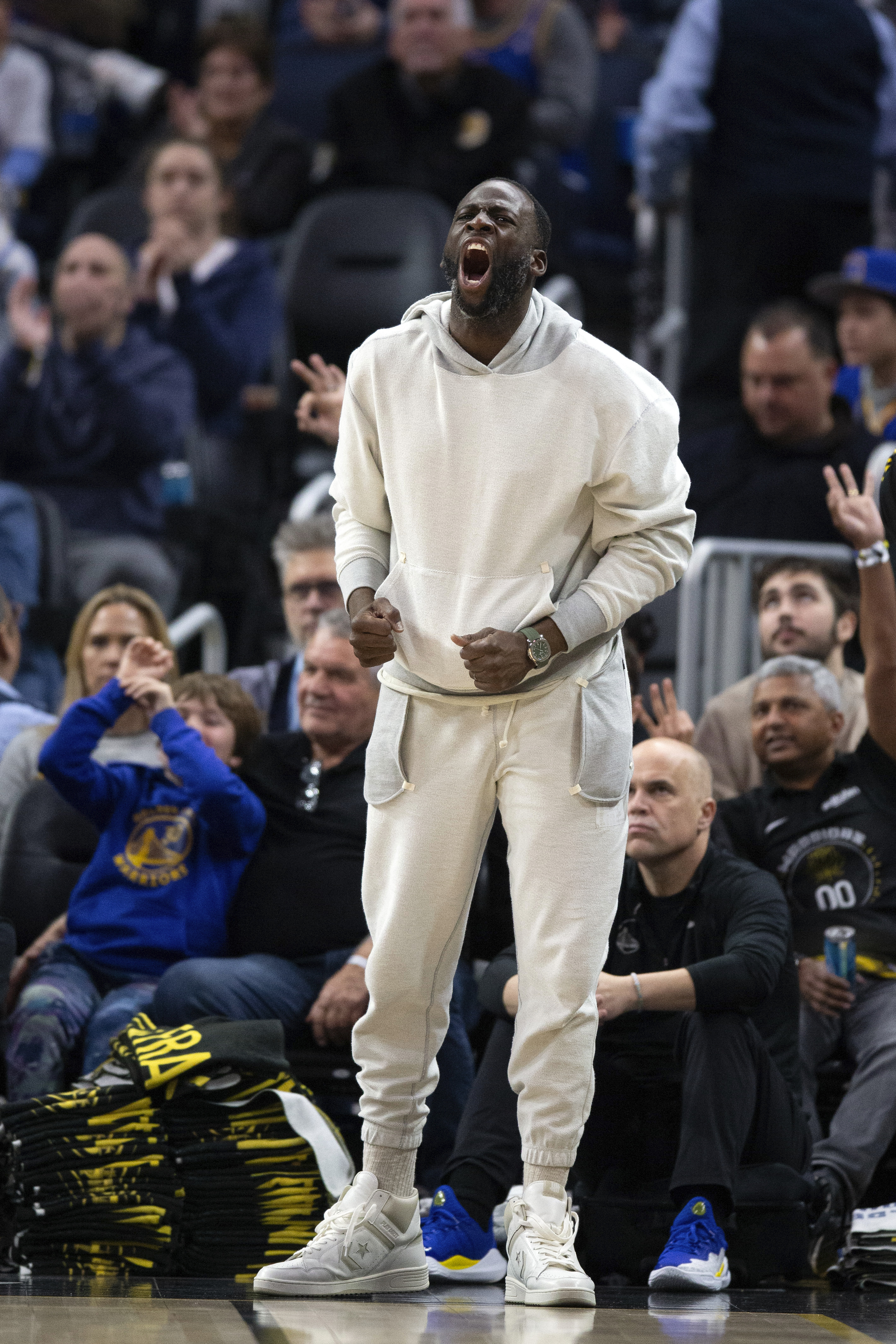 Golden State Warriors forward Draymond Green, center, reacts to his team's play against the Toronto Raptors during the third quarter of an NBA basketball game, Sunday, Jan. 7, 2024, in San Francisco. Although Green has been reinstated from his suspension, he did not play in Sunday's game. 